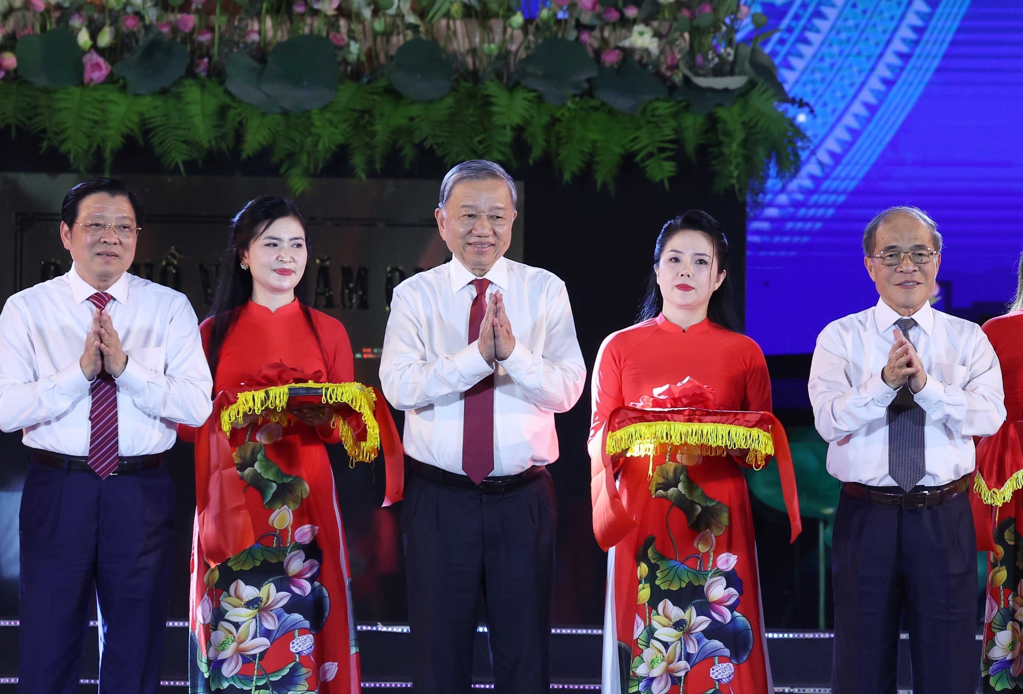 Tổng Bí thư Tô Lâm và các đại biểu thực hiện nghi thức cắt băng khánh thành Tượng đài "Bác Hồ về thăm quê" tại tỉnh Nghệ An.