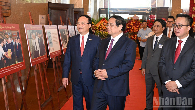 Thủ tướng Phạm Minh Chính xem triển lãm ảnh về quá trình xây dựng và trưởng thành của Đài Tiếng nói Việt Nam. (Ảnh: TRẦN HẢI)