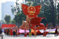 The vehicle carries the model of the National Emblem of the Socialist Republic of Vietnam in the parade. (Photo: VNA)