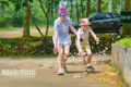 Chidlren play with butterflies in Cuc Phuong national park.