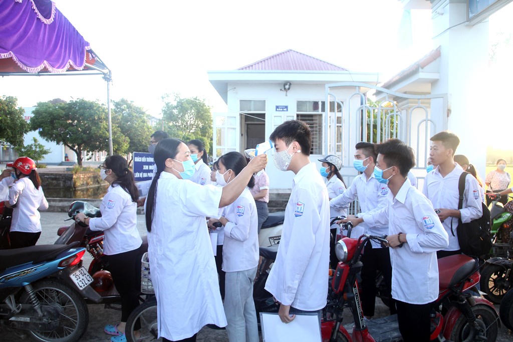 Body temperature checking before entering the exam.