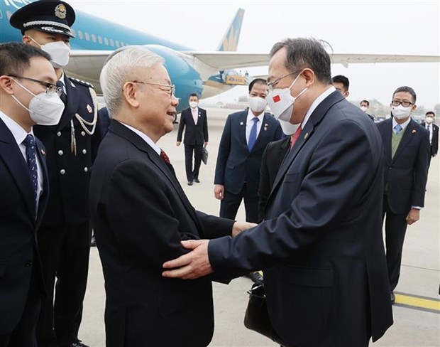 Head of the International Liaison Commission of the Central Committee of the Communist Party of China Liu Jianchao (R) welcomes Party General Secretary Nguyen Phu Trong at the Beijing International Airport on October 30.