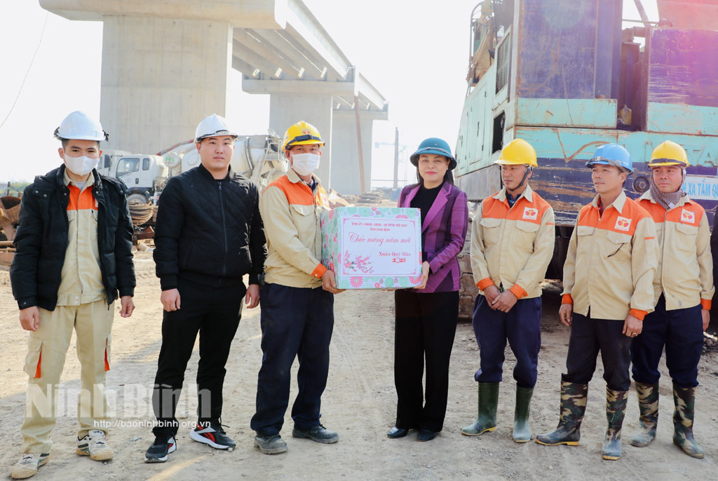 Secretary of the provincial Party Committee Nguyen Thi Thu Ha presents gifts to workers at project of building coastal road running through Kim son district.